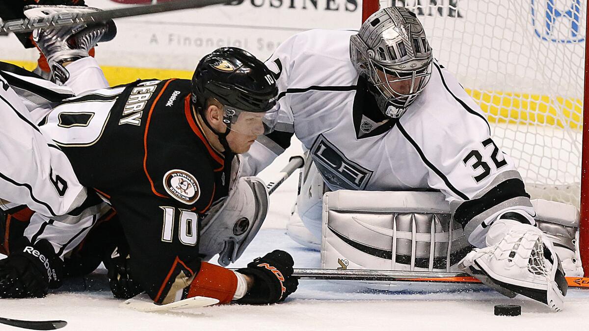 Kings goalie Jonathan Quick moves to cover the puck in front of Ducks forward Corey Perry during the Ducks' season-ending loss in Game 7 of the Western Conference semifinals Friday. Perry says the Ducks' playoff exit could act as a motivating factor for next season.