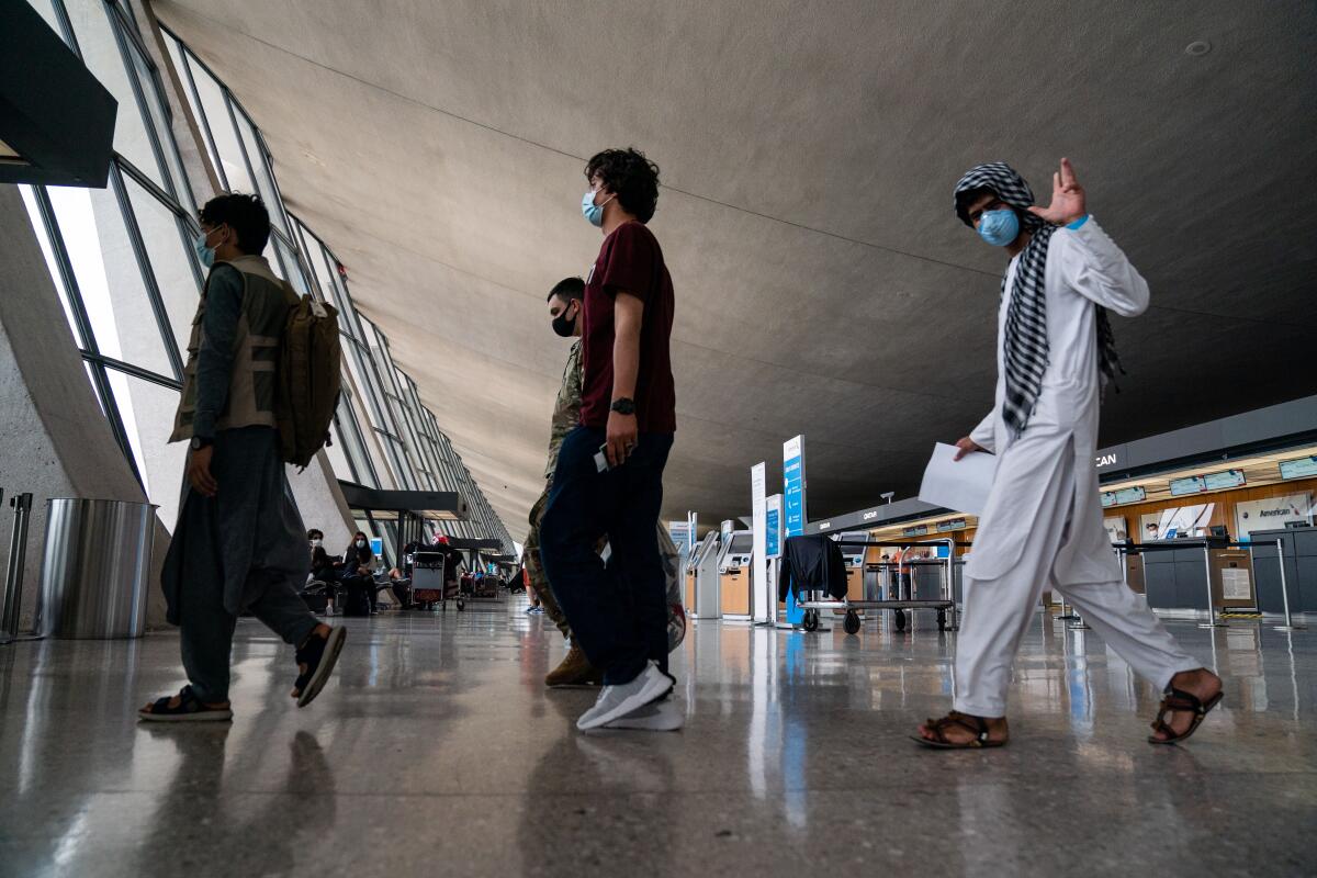 People walk through an airport terminal