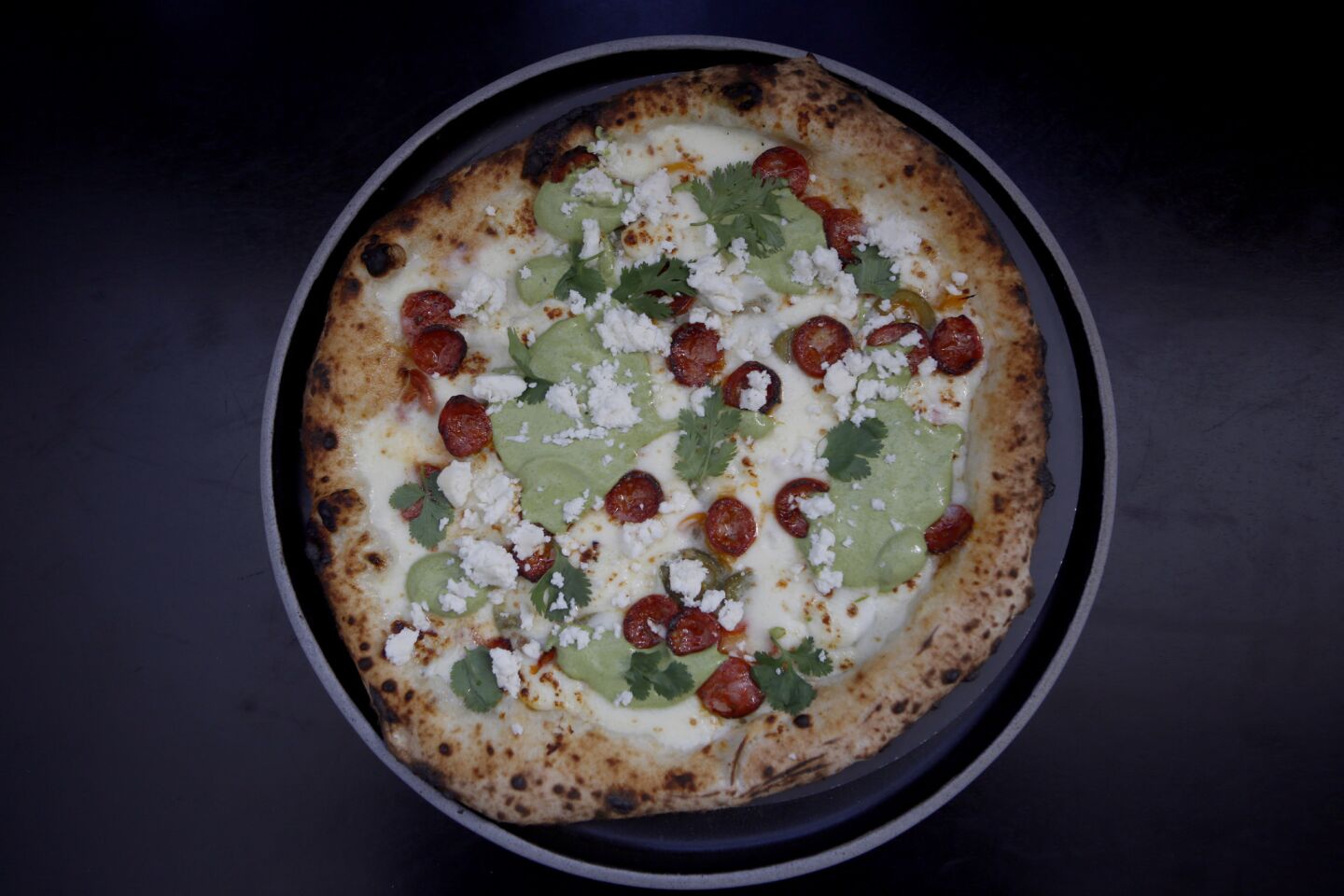 This one's called the Messicana: chorizo, cilantro lime sauce, queso fresco, jalapeno and pickled sweet chile.
