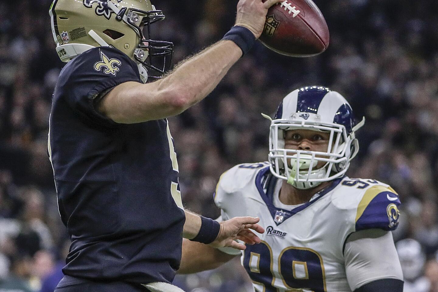Rams defensive lineman Aaron Donald chases New Orleans Saints quarterback Drew Brees during second half action in the NFC Championship at the Superdome.