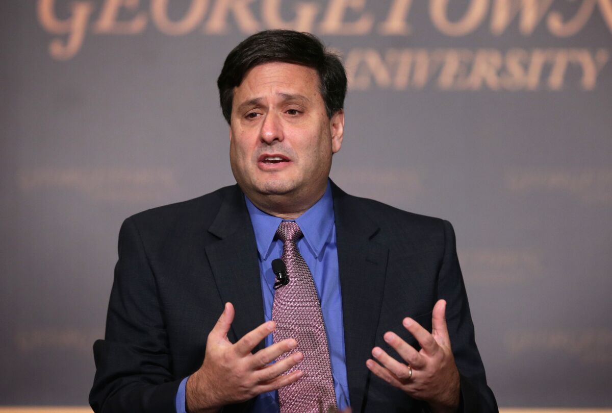 Ron Klain gestures while speaking at a conference