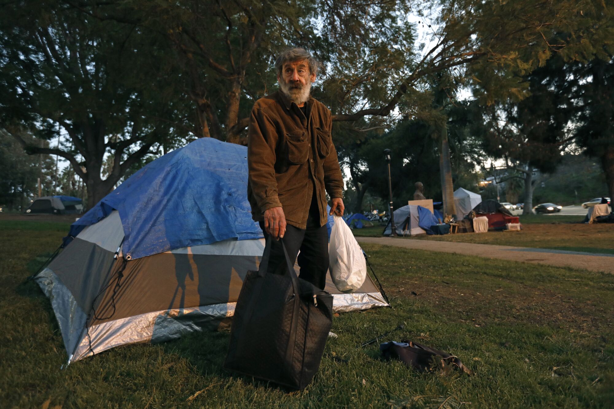 Frank Chiaro,  71, sets up a new tent at Echo Park.