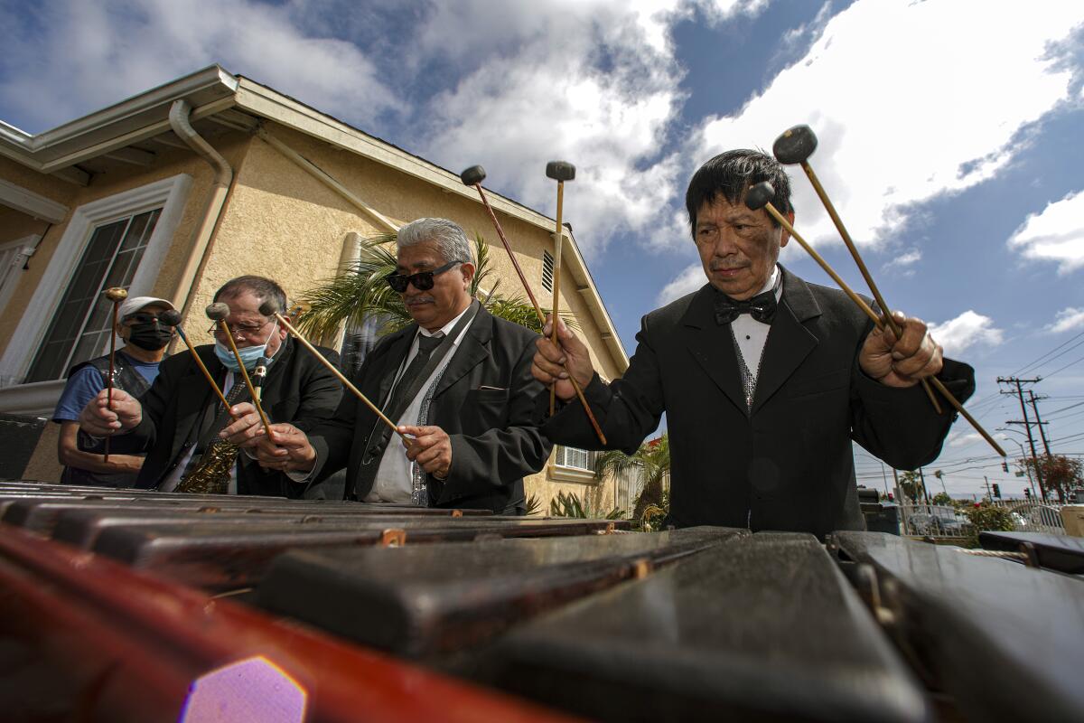 Rosauro "Chaury" Esteban, right, and his marimba orchestra group, Perla Tuneca, play at a fundraiser