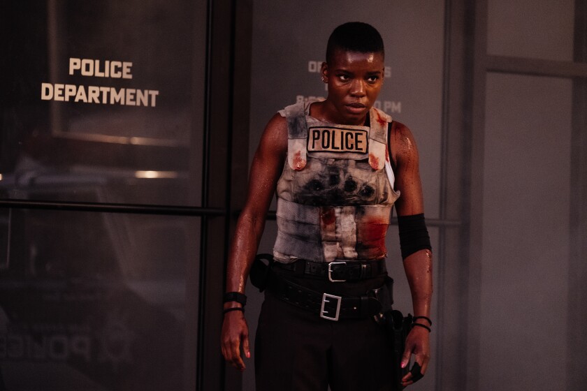 A battle-scarred policewoman in the movie "Copshop."