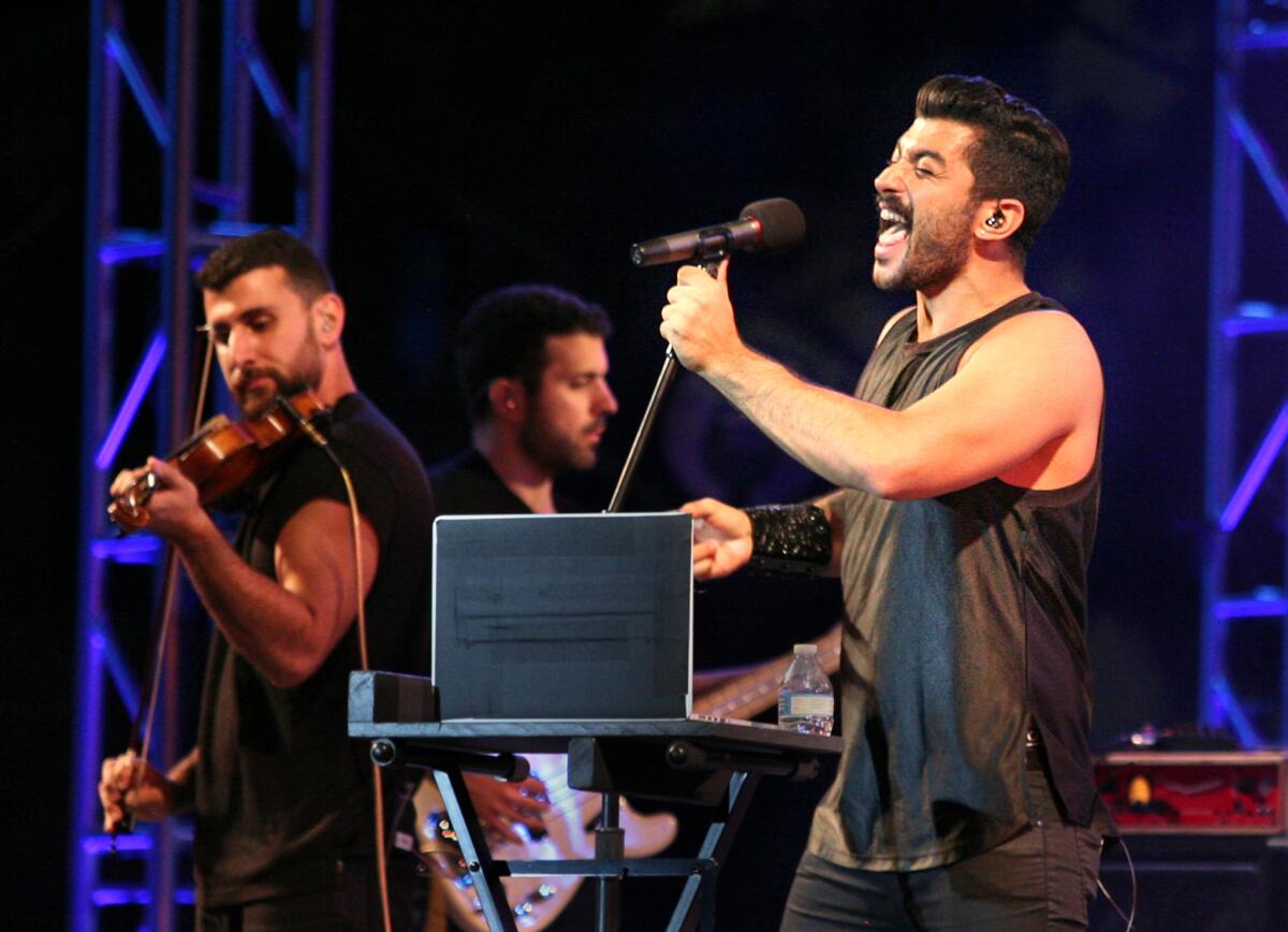 The band Mashrou' Leila, a Lebanese five-piece alternative rock group, performed downtown as part of Grand Performances on Friday night. At right is lead singer Hamed Sinno.