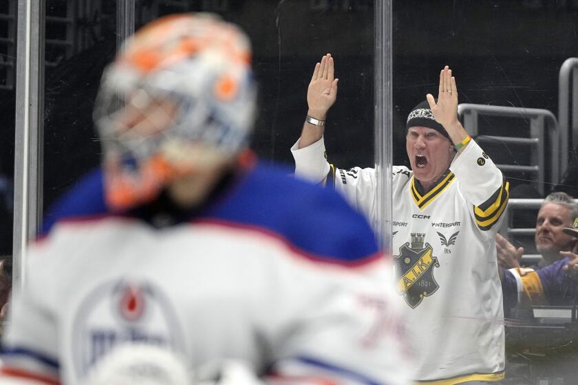 Actor Will Ferrell, right, cheers as Edmonton Oilers goaltender Stuart Skinner stands in goal during the second period in Game 4 of an NHL hockey Stanley Cup first-round playoff series between the Los Angeles Kings and the Oilers Sunday, April 28, 2024, in Los Angeles. (AP Photo/Mark J. Terrill)