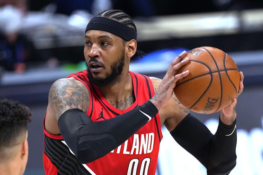 Portland Trail Blazers forward Carmelo Anthony looks to pass the ball against the Denver Nuggets.