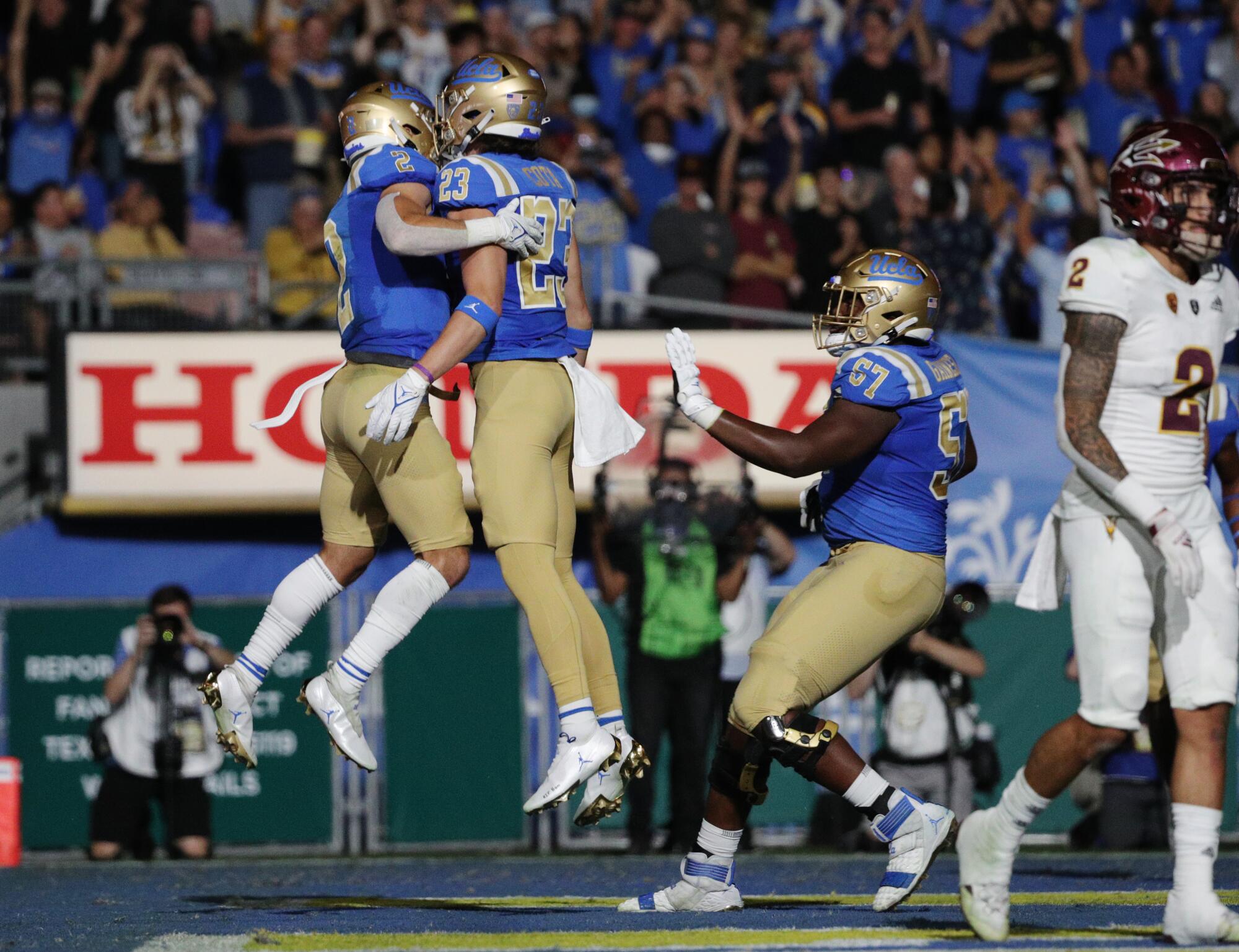 UCLA wide receiver Kyle Philips celebrates his touchdown catch with teammate Chase Cota.