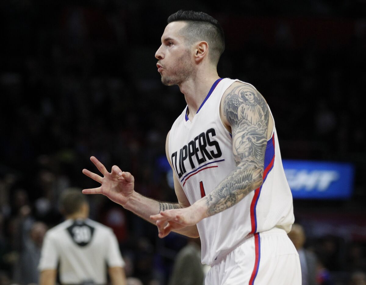 Clippers guard J.J. Redick gestures with his fingers after sinking a 3-point shot 