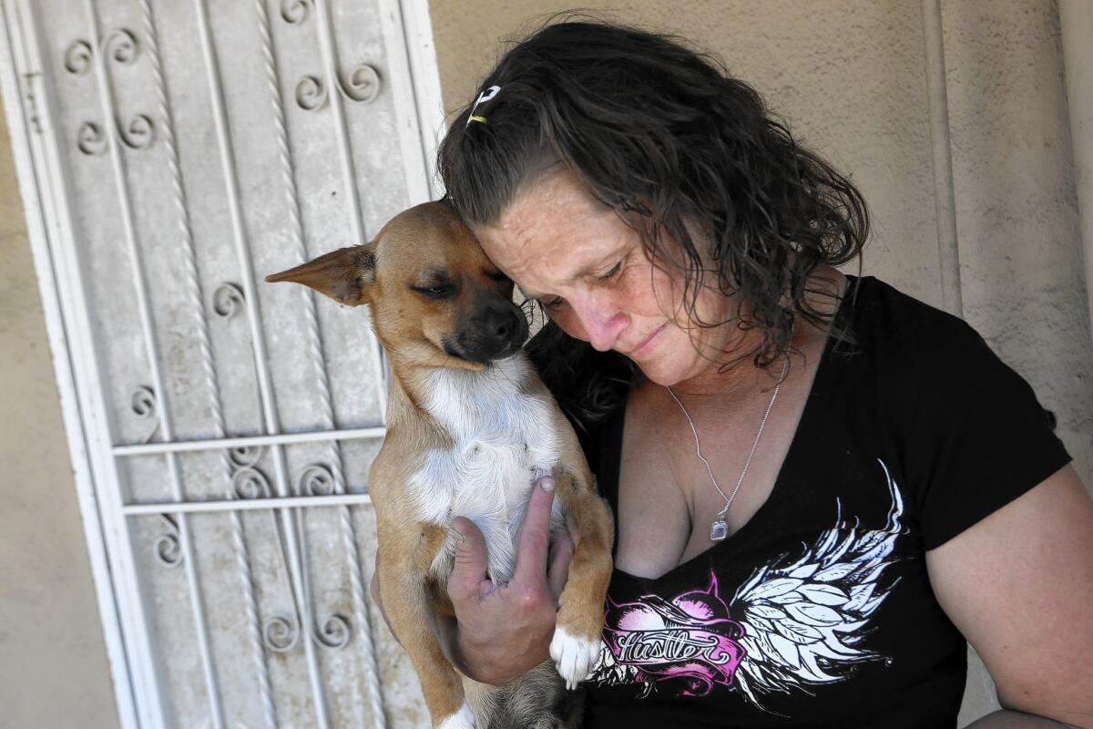 Kathleen Anderson outside the abandoned home she and her husband, Johnny Ray Anderson, were living in when he was fatally shot by L.A. County sheriff's deputies in Hawaiian Gardens on Sunday.