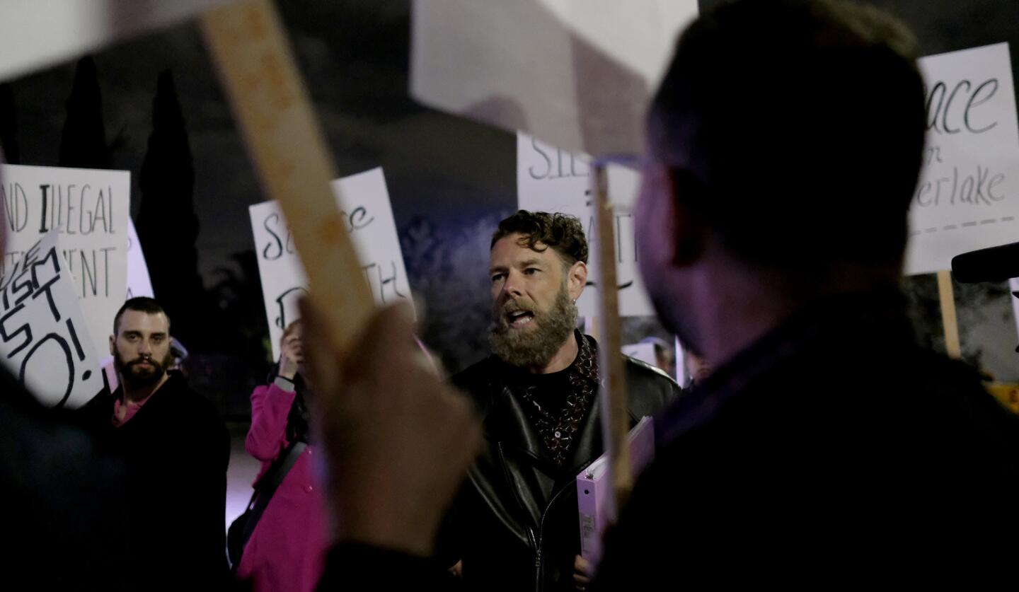 Daniel Henning speaks to the crowd on Saturday night outside the Black Cat tavern in Silver Lake.