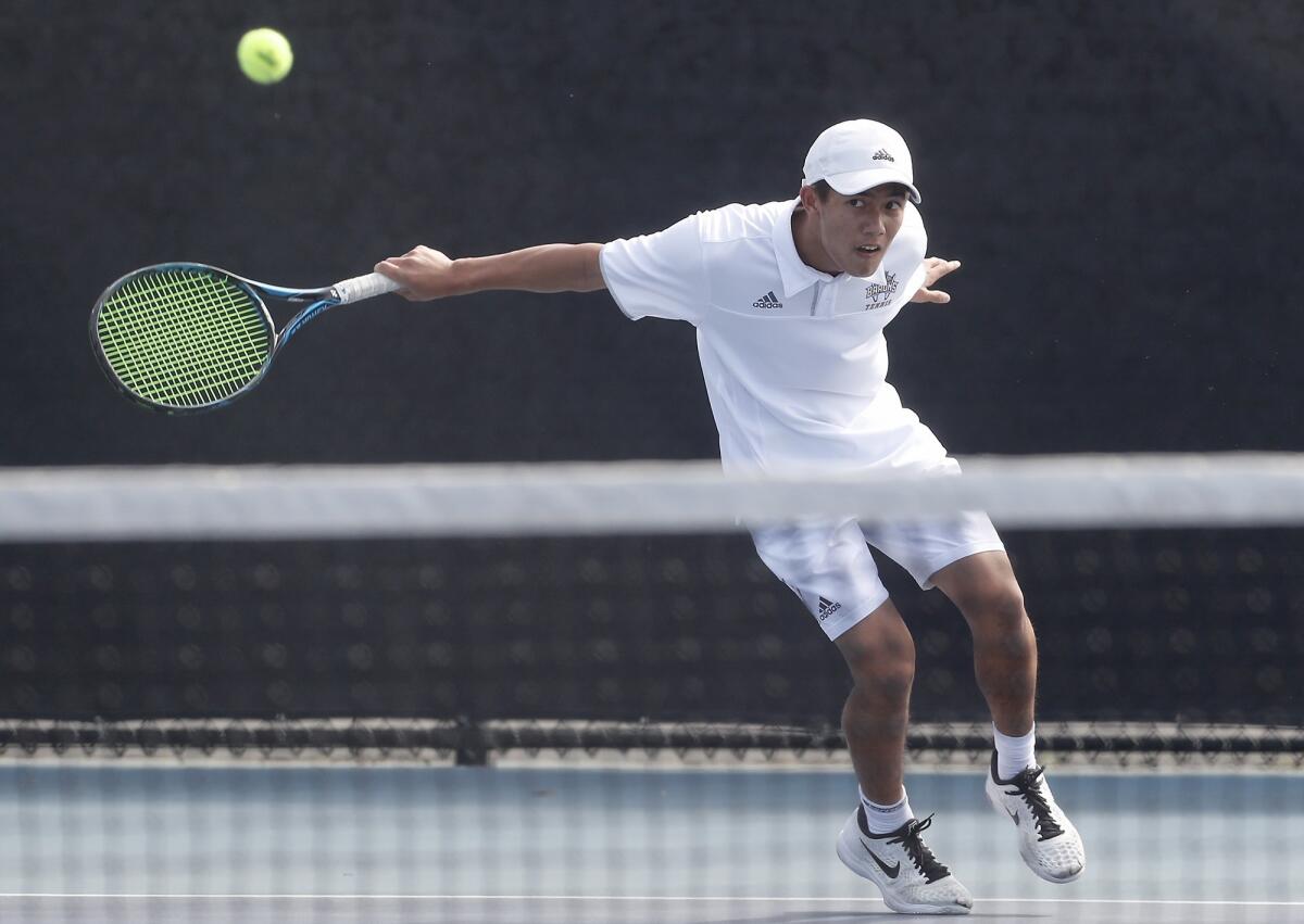 Fountain Valley High's Justin Nguyen competes in a No. 1 singles set of a Surf League match at Corona del Mar on Thursday.