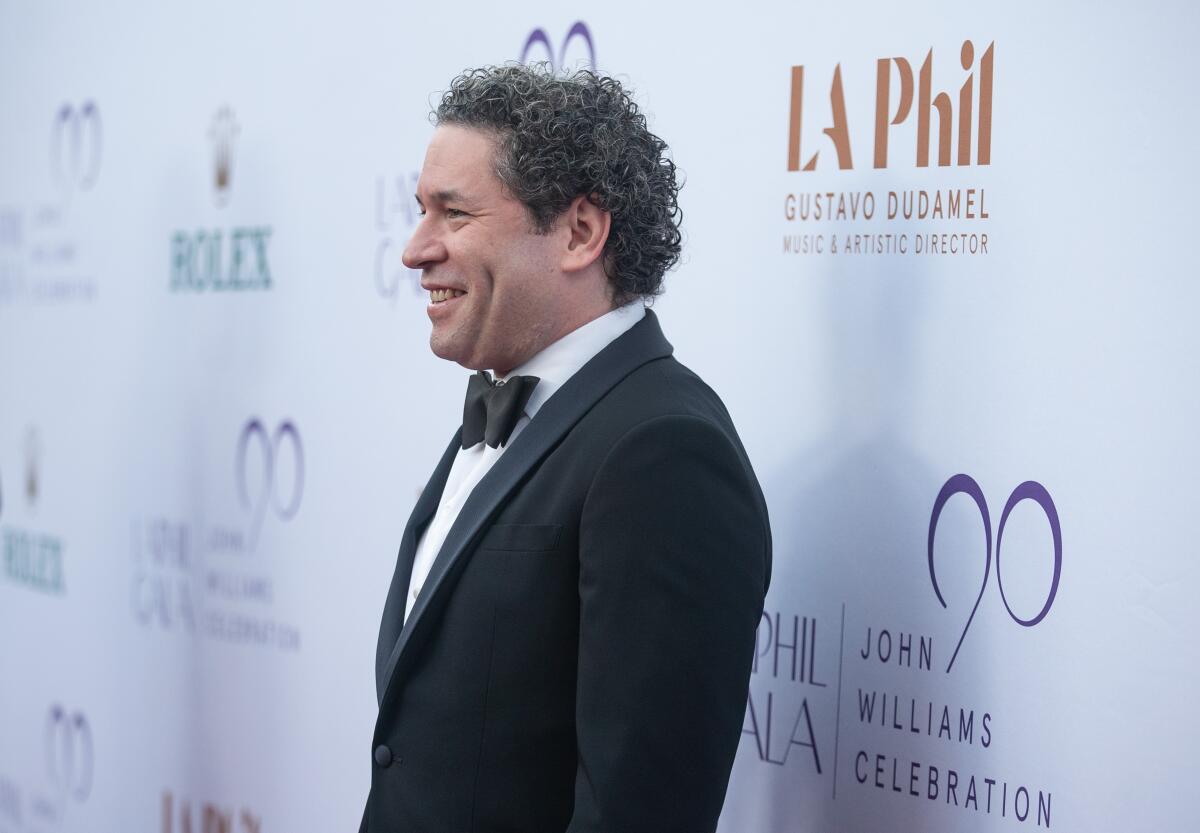 Gustavo Dudamel poses on the red carpet in a tuxedo.