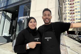 Anwar Jibawi and his mother Amal Jibawi outside of their restaurant Anwar's Kitchen in downtown.