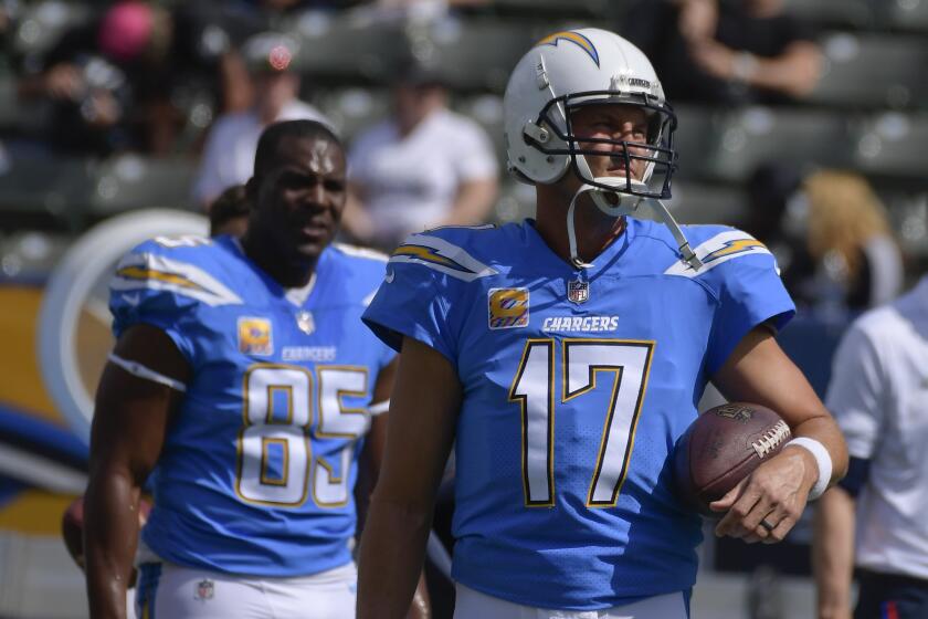 Chargers Antonio Gates and Philip Rivers stand on the sideline before a game in 2018.