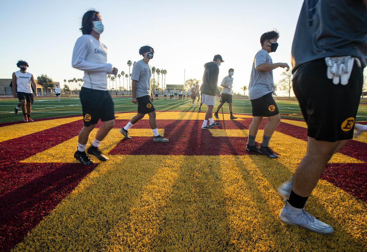 Estancia High School football players stay socially distanced during Thursday's practice.