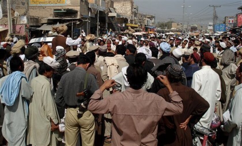 Pakistani people from Mehsud tribe rally to condemn U. S. missile attacks in their areas along the Afghanistan border, in Tank, 60 kilometers (37 miles) from Dera Ismail Khan on Wednesday, April 1, 2009 in Pakistan. A suspected U. S. drone fired two missiles at an alleged hide-out connected to a Taliban leader who has threatened to attack Washington, killing 12 people and wounding several others, official said. (AP Photo/Ishtiaq Mehsud)