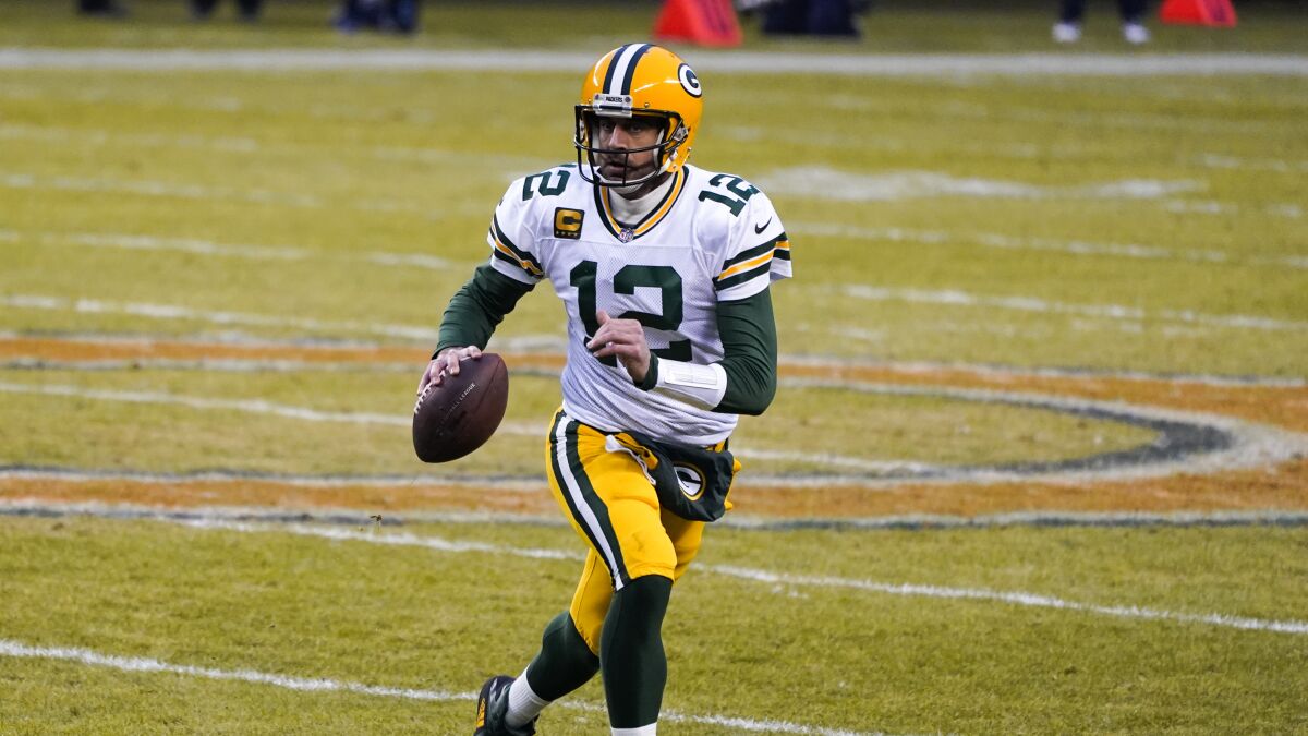 Green Bay Packers' Aaron Rodgers runs during the first half of an NFL football game against the Chicago Bears.