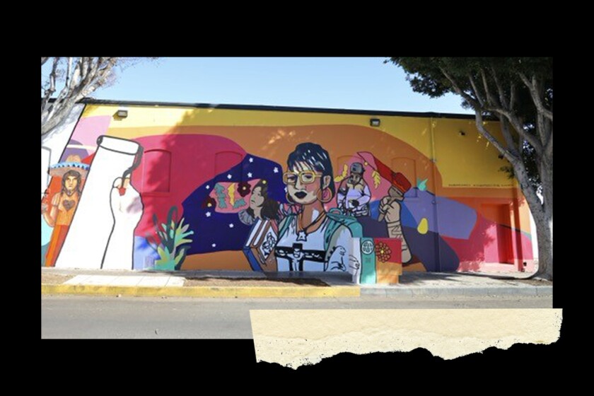 A brightly colored mural on the side of a building is seen from the street.