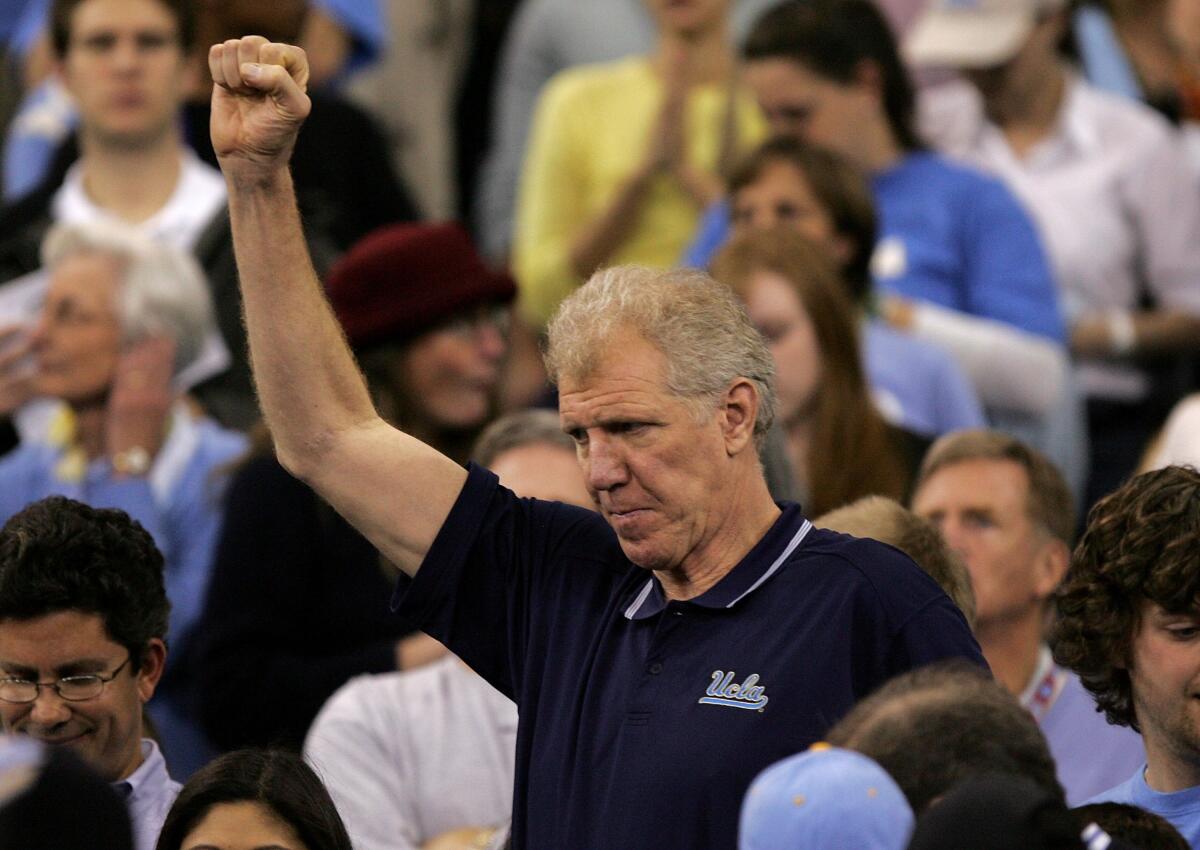 Bill Walton raises a fist to cheer on UCLA against the Florida Gators during the 2006 national championship game.