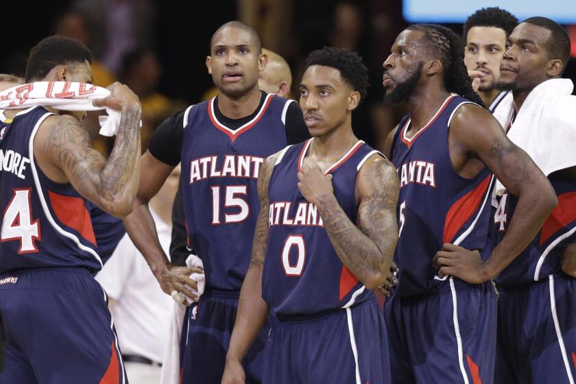 Hawks forward Al Horford watches as the referees look at a replay monitor during the first half of Game 3 of the Eastern Conference finals.