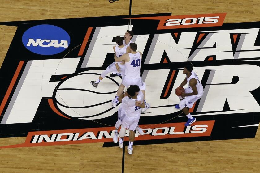 FILE - Duke players celebrate after the NCAA Final Four college basketball tournament championship game against Wisconsin in Indianapolis, in this Monday, April 6, 2015, file photo. The NCAA announced Monday, Nov. 16, 2020, it plans to hold the entire 2021 men’s college basketball tournament in one geographic location to mitigate the risks of COVID-19 and is in talks with Indianapolis to be the host city (AP Photo/David J. Phillip, File)