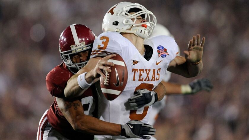 Texas quarterback Garrett Gilbert (3) fumbles the ball as he is hit by Alabama linebacker Eryk Anders (32) during the BCS National Championship game at the Rose Bowl on January 7, 2010.