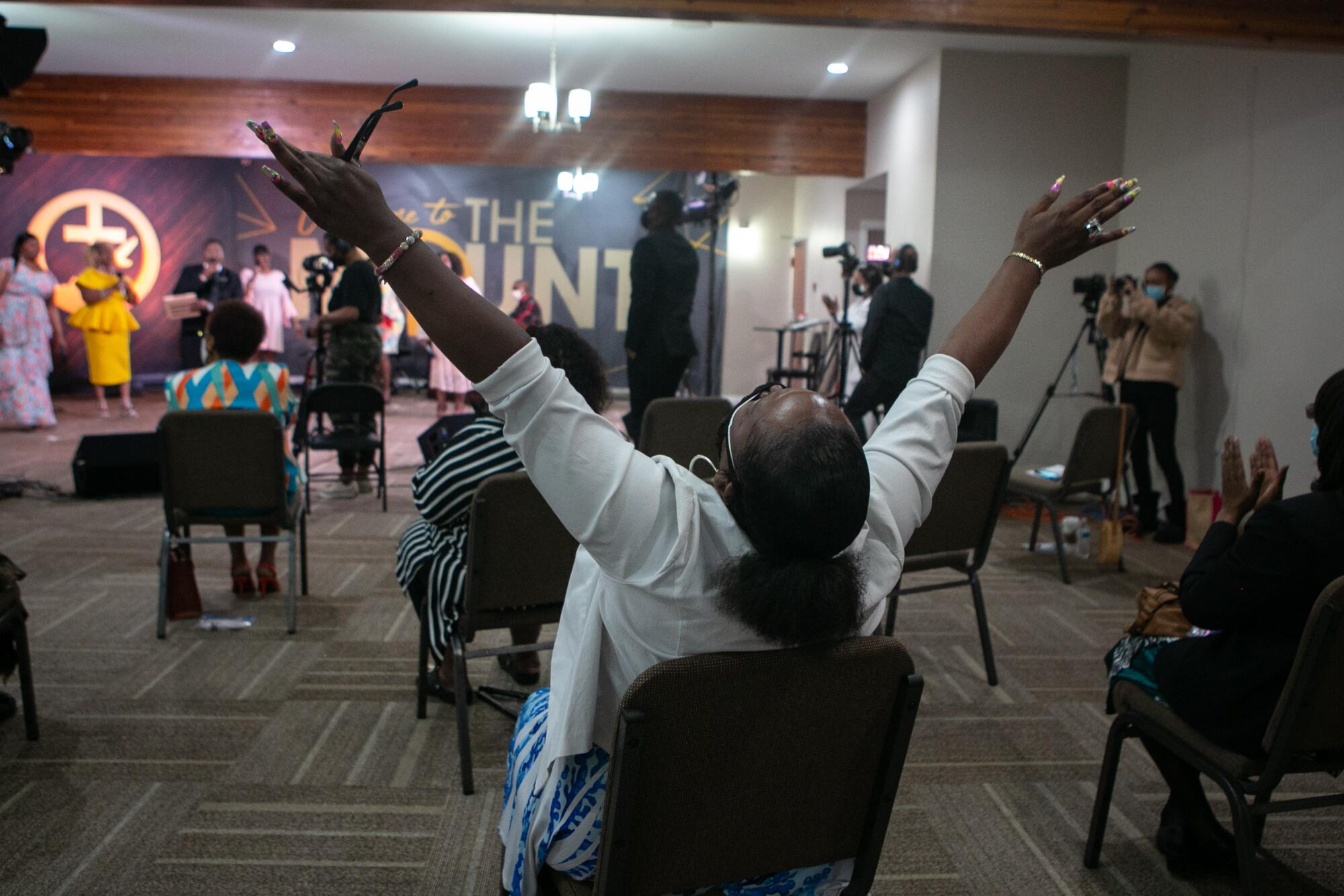 A church member raises her hands during Easter service.
