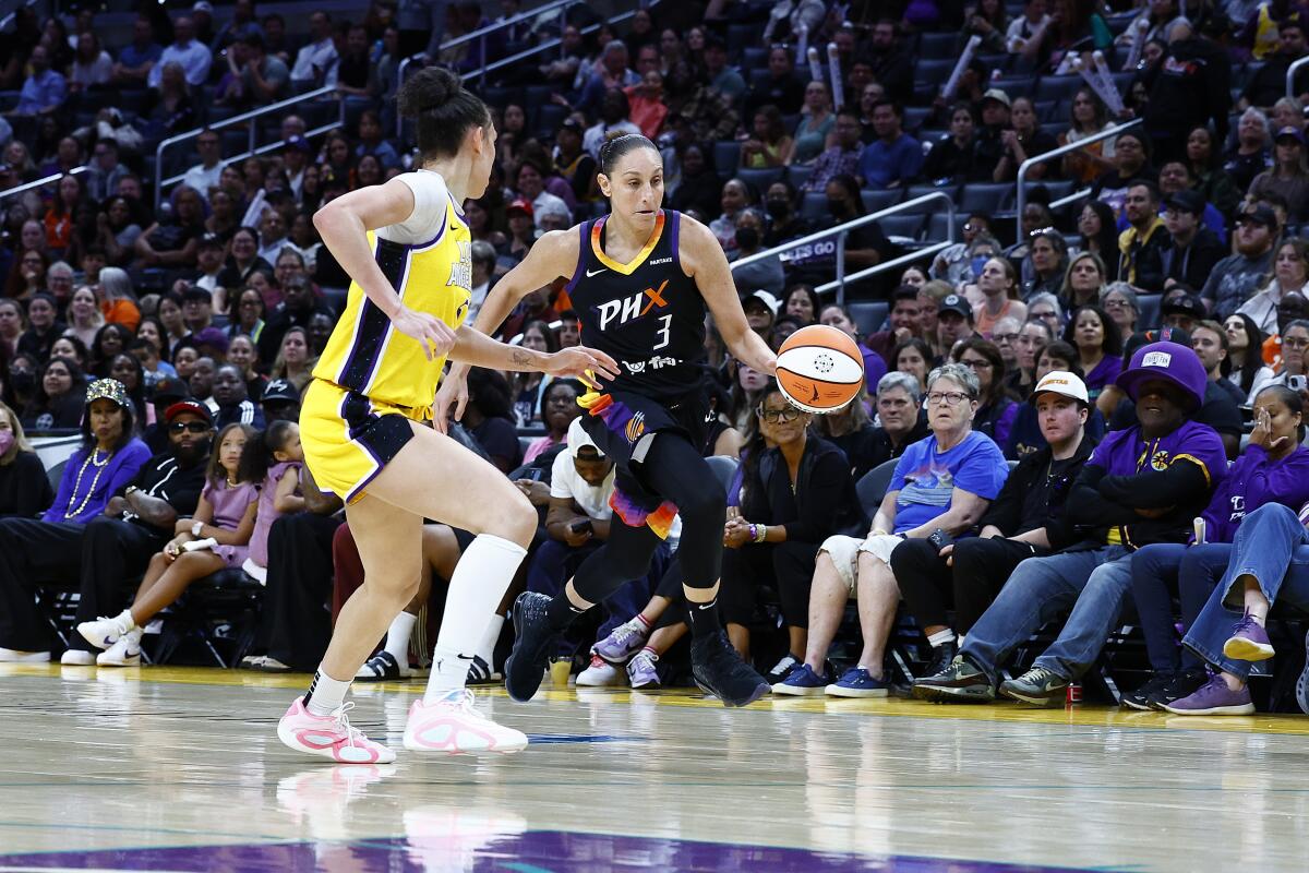 Diana Taurasi of Phoenix controls the ball against Kia Nurse