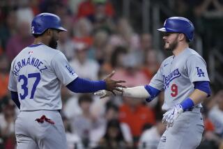 Los Angeles Dodgers' Gavin Lux, right, celebrates with Teoscar Hernández, left, after hitting a two-run home run during the sixth inning of a baseball game against the Houston Astros, Sunday, July 28, 2024, in Houston. (AP Photo/Kevin M. Cox)