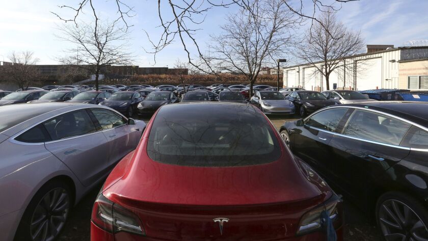Tesla vehicles sit in a parking lot in Chicago.