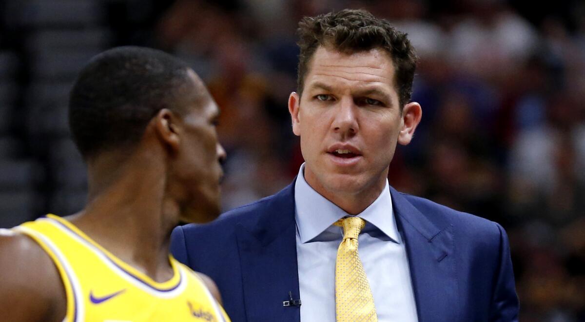 Lakers coach Luke Walton speaks with guard Rajon Rondo during a game on March 27.