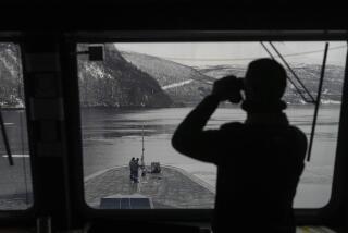 A French sailor uses binoculars to scan the area as others stand on the bow of the French navy frigate Normandie during a docking manoeuvre in a Norwegian fjord, north of the Arctic circle, Friday March 8, 2024. The French frigate is part of a NATO force conducting exercises in the seas, north of Norway, codenamed Steadfast Defender, which are the largest conducted by the 31 nation military alliance since the cold war. (AP Photo/Thibault Camus)