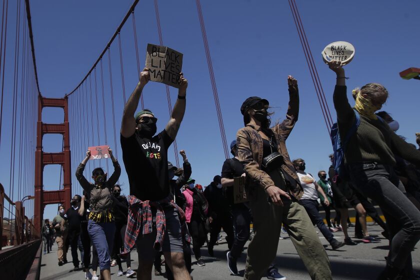 People march as traffic is stopped on the Golden Gate Bridge in San Francisco, Saturday, June 6, 2020, at a protest over the Memorial Day death of George Floyd. Floyd died May 25 after being restrained by Minneapolis police. (AP Photo/Jeff Chiu)