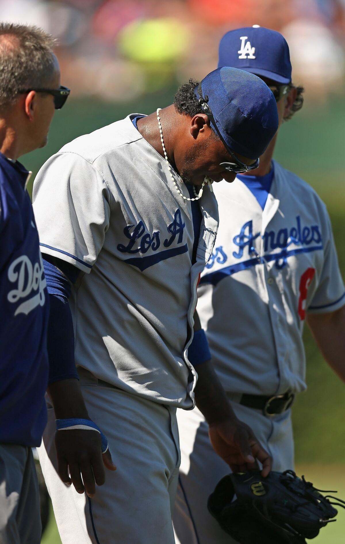 Dodgers shortstop Hanley Ramirez walks off the field after injuring his shoulder against the Chicago Cubs on Sunday.