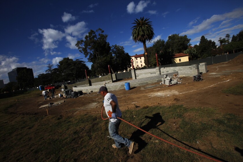 Workers building the Hollywood Canteen Amphitheater at the Veterans Affairs' West Los Angeles campus in November, before a judge halted work. The VA has canceled a parking deal for next month's PGA golf tournament at Riviera Country Club.