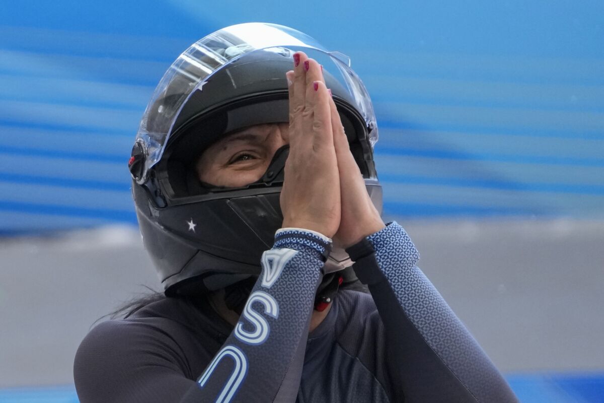 Elana Meyers Taylor, of the United States, celebrates after the finish during the women's monobob heat 4 at the 2022 Winter Olympics, Monday, Feb. 14, 2022, in the Yanqing district of Beijing. (AP Photo/Pavel Golovkin)