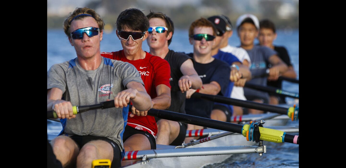 Members of the San Diego Rowing Club's men's varsity squad practice on Mission Bay.