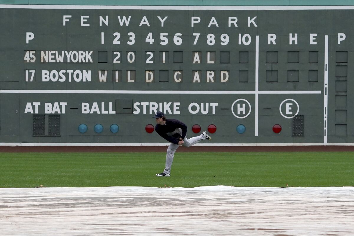 New York Yankees starting pitcher Gerrit Cole throws in the outfield during the American League Wild Card Workout Day at Fenway Park, Monday, Oct. 4, 2021, before Tuesday's American League Wild Card game against the Boston Red Sox in Boston. (AP Photo/Mary Schwalm)