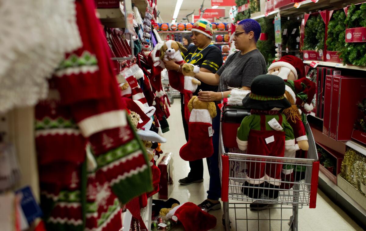 Katie Rainey of Los Angeles, left, and Michelle Roache of Burbank fill their shopping cart with Christmas decorations with a pet theme at Kmart in Burbank in 2013. Early data says Super Saturday surpassed Black Friday in sales this year.