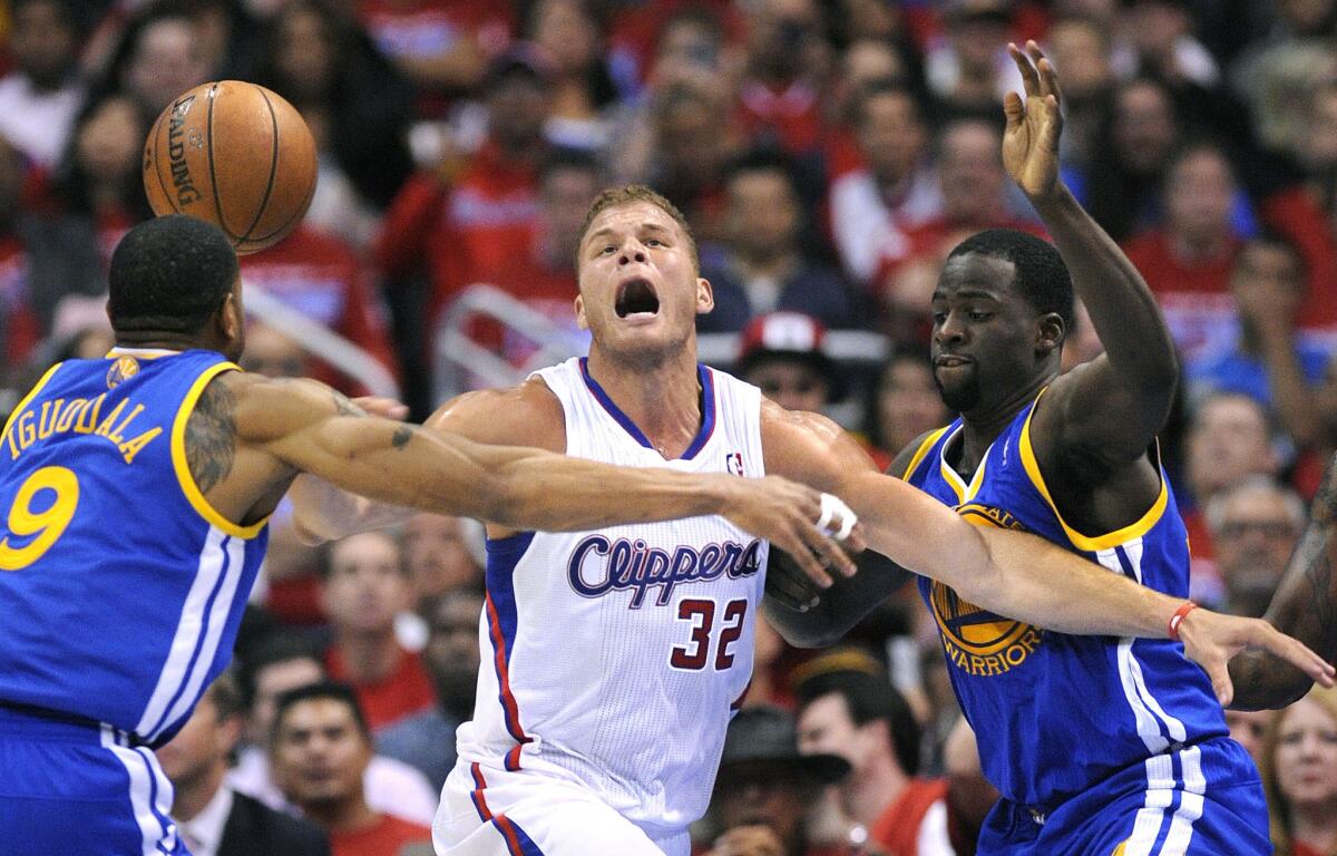 Blake Griffin loses control of the ball against the Warriors' Andre Iguodala, left, and Draymond Green in Game 2 of their first-round playoff series at Staples Center.