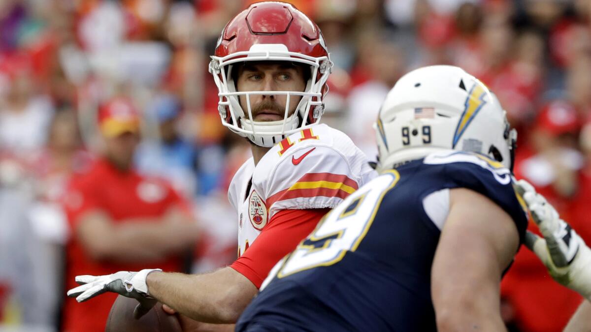 Chiefs quarterback Alex Smith looks to pass against the Chargers during the first half Sunday.