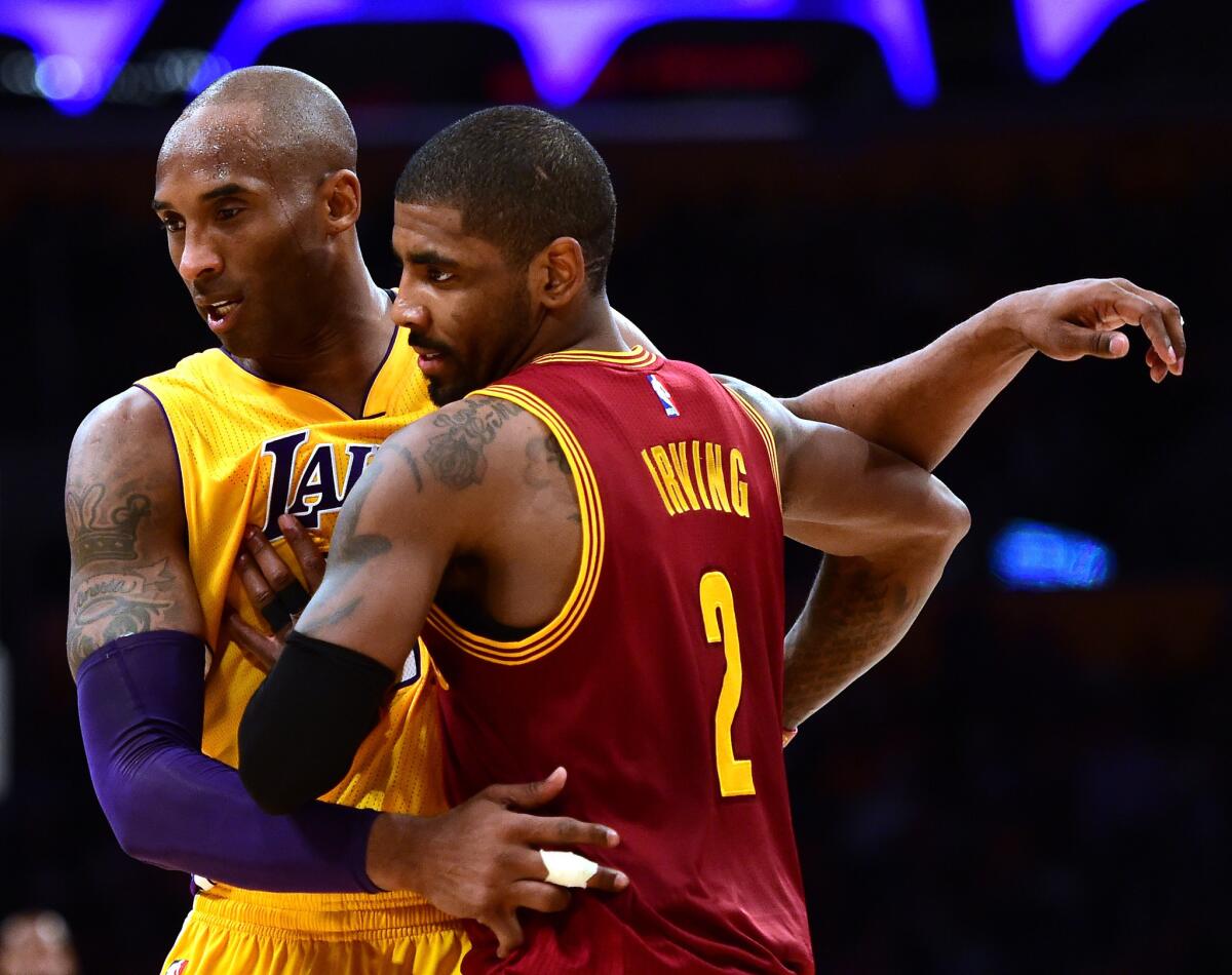 Lakers forward Kobe Bryant (24) guards Cavaliers point guard Kyrie Irving (2) during a 120-108 Cavaliers win at Staples Center on March 10.