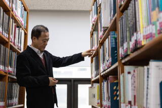 A man searches for a book in a library in Seoul