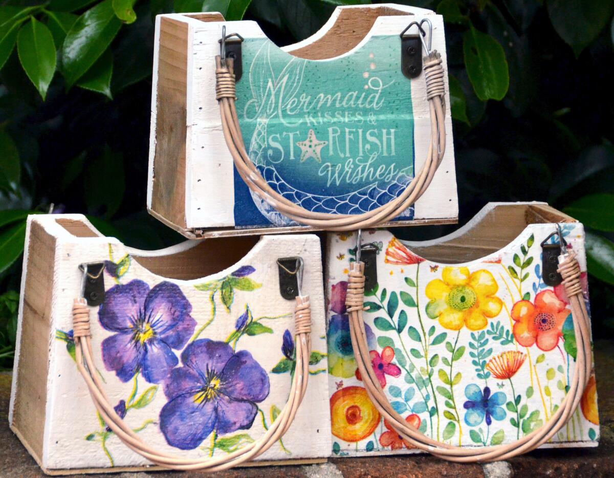 Artist Sandy Rainer's decoupage purse planters were popular at the Spring Garden Art Faire.