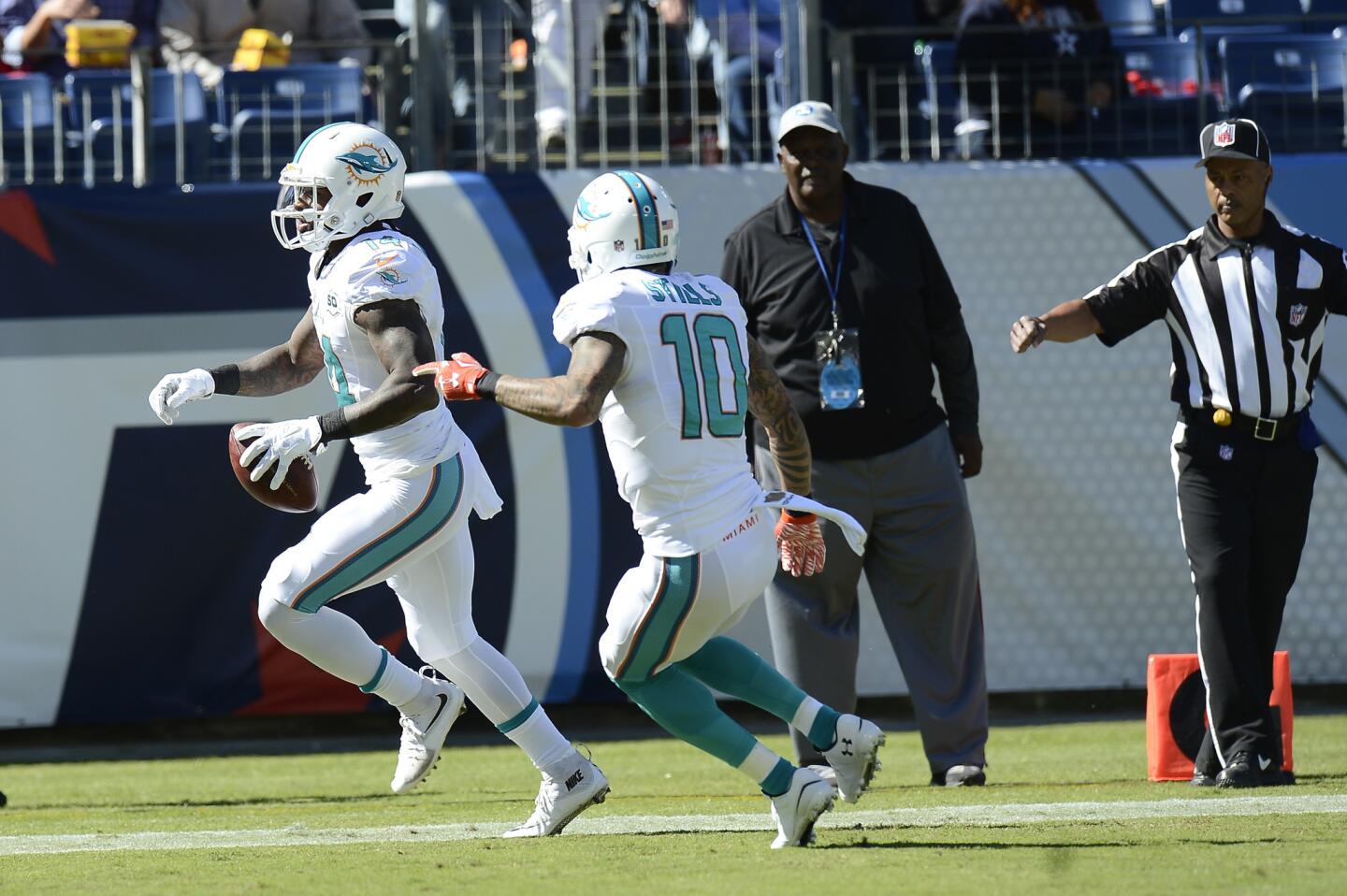 Miami Dolphins wide receiver Jarvis Landry (14) scores a touchdown against the Tennessee Titans in the first half of an NFL football game Sunday, Oct. 18, 2015, in Nashville, Tenn. At right is wide receiver Kenny Stills (10). (AP Photo/Mark Zaleski) ORG XMIT: TNMH1