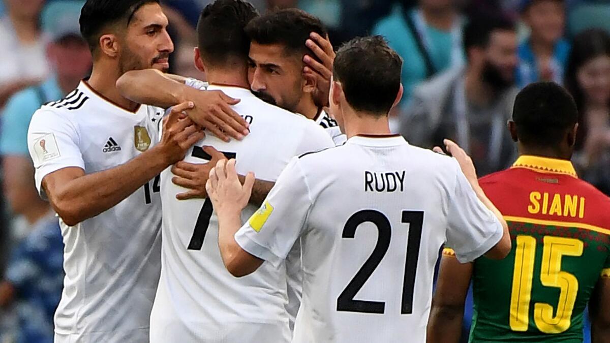 German players celebrate after scoring a goal against Cameroon on Sunday.