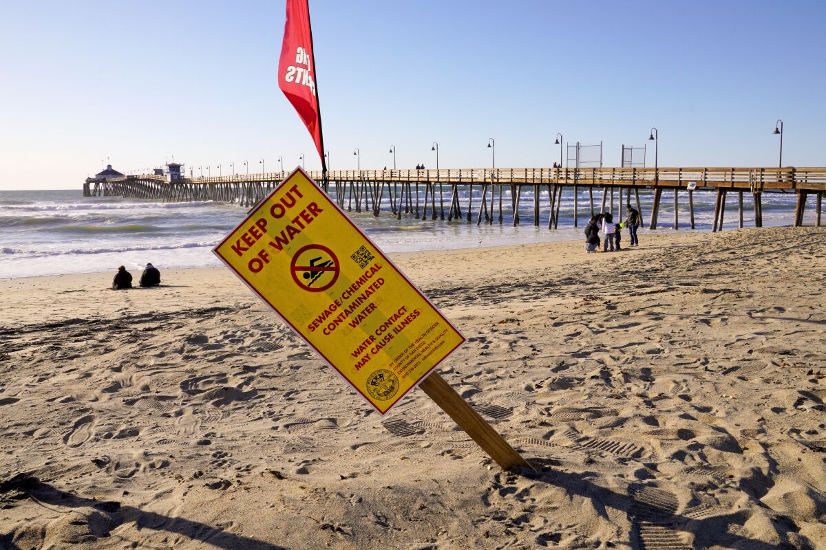 A water contamination sign warns beach goers about high bacteria in the water in Imperial Beach on February 15, 2023. 