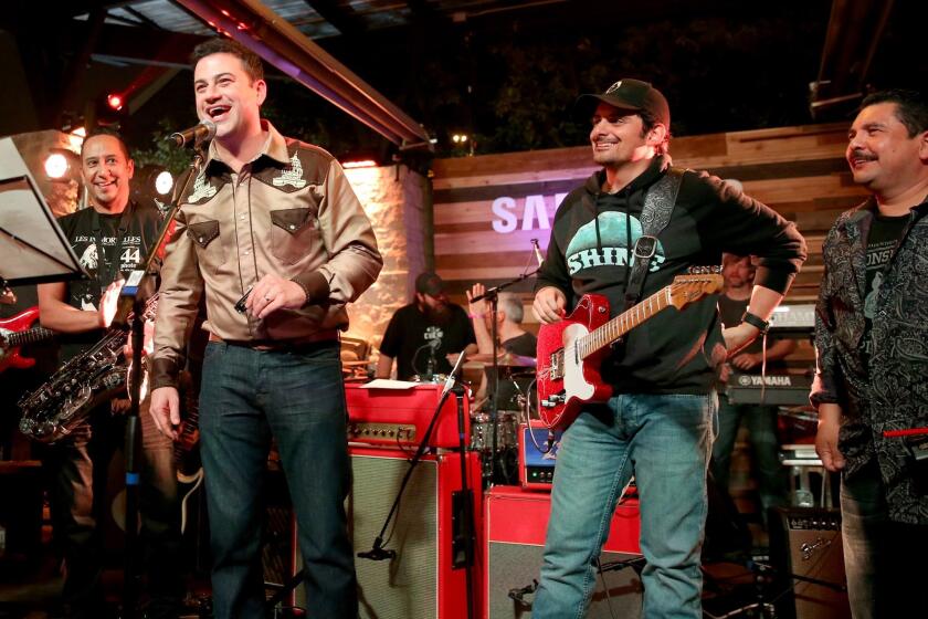 Musician Cleto Escobedo Jr., left, host Jimmy Kimmel, singer Brad Paisley and TV personality Guillermo Rodriguez perform at a party in Austin, Texas during SXSW.