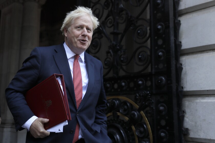 Britain's Prime Minister Boris Johnson returns to Downing Street after attending a cabinet meeting in London, Tuesday, Sept. 1, 2020. Britain's Parliament resumes Tuesday following the summer break. (AP Photo/Kirsty Wigglesworth)